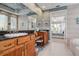 Bright bathroom features granite counters, double sinks, vanity, tile flooring, and views to the bedroom at 3895 Mimosa Pl, Palm Harbor, FL 34685