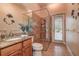 Bathroom boasts a glass shower, granite counters, sink, and walk-out door to outdoor area at 3895 Mimosa Pl, Palm Harbor, FL 34685