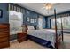 Charming bedroom with four-poster bed, patterned bedding, ceiling fan, and bright, natural light at 3895 Mimosa Pl, Palm Harbor, FL 34685