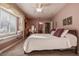 This bedroom has a ceiling fan, a comfortable bed, and a large window seat for relaxing at 3895 Mimosa Pl, Palm Harbor, FL 34685