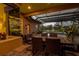 Covered patio with room for dining overlooks screened pool, spa, and lake at 3895 Mimosa Pl, Palm Harbor, FL 34685