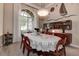 Warm dining room with large window, stylish light fixture, and built-in cabinet at 3895 Mimosa Pl, Palm Harbor, FL 34685