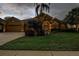 Beautifully landscaped exterior elevation of home with 2 car garage and covered entry at 3895 Mimosa Pl, Palm Harbor, FL 34685