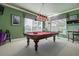 Fun game room with a billiard table, chandelier and light from the ample windows at 3895 Mimosa Pl, Palm Harbor, FL 34685