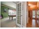 Doorway view of game room featuring billiard table and bath, enhancing entertainment and convenience at 3895 Mimosa Pl, Palm Harbor, FL 34685