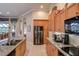 Modern kitchen featuring stainless appliances, granite counters, and wood cabinetry at 3895 Mimosa Pl, Palm Harbor, FL 34685
