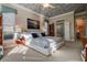 Well lit main bedroom featuring tray ceiling, large windows, and doorway to ensuite bathroom at 3895 Mimosa Pl, Palm Harbor, FL 34685
