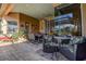 Extended patio area with diverse seating, outdoor dining, and access to the pool, ideal for entertaining and relaxation at 3895 Mimosa Pl, Palm Harbor, FL 34685