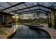 Screened pool and attached spa with views of the lake at 3895 Mimosa Pl, Palm Harbor, FL 34685
