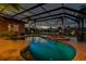 Inviting screened pool and spa with brick pavers and lovely water views make this a relaxing outdoor space at 3895 Mimosa Pl, Palm Harbor, FL 34685