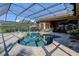 Sparkling pool under a screened enclosure, surrounded by a brick patio, offering a private oasis for swimming at 3895 Mimosa Pl, Palm Harbor, FL 34685