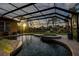 Screened pool and attached spa with views of the lake at 3895 Mimosa Pl, Palm Harbor, FL 34685