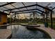 Beautiful pool and spa area featuring brick accents and an enclosed screen, perfect for outdoor relaxation at 3895 Mimosa Pl, Palm Harbor, FL 34685