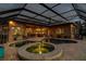 Screened pool with attached spa and views of the home's interior at 3895 Mimosa Pl, Palm Harbor, FL 34685
