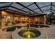 Screened pool with attached spa and views of the home's interior at 3895 Mimosa Pl, Palm Harbor, FL 34685
