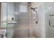 Contemporary frameless glass shower with dual shower heads and a built-in seat at 3895 Mimosa Pl, Palm Harbor, FL 34685