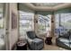 Cozy sitting area with comfortable chairs, bay window, and peaceful outdoor views at 3895 Mimosa Pl, Palm Harbor, FL 34685