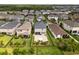 Aerial view of the backyard featuring a paved patio and a dark metal fence at 4077 Cadence Loop, Land O Lakes, FL 34638