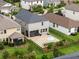 Aerial view of a backyard featuring a paved patio and a dark metal fence at 4077 Cadence Loop, Land O Lakes, FL 34638