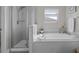 Bright bathroom features a tub and a separate glass enclosed shower at 4077 Cadence Loop, Land O Lakes, FL 34638