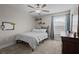 Comfortable bedroom features ceiling fan, a bed, and a dresser at 4077 Cadence Loop, Land O Lakes, FL 34638