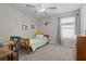 Comfortable bedroom with ceiling fan, desk, and plenty of natural light at 4077 Cadence Loop, Land O Lakes, FL 34638