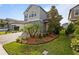 Charming two-story home with landscaped yard, brick driveway, two-car garage, and neutral gray paint at 4077 Cadence Loop, Land O Lakes, FL 34638