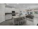 Bright kitchen offers white cabinets, quartz countertops, a breakfast bar, and a dining area at 4077 Cadence Loop, Land O Lakes, FL 34638