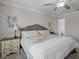 Bright bedroom featuring a ceiling fan, neutral color scheme, and en-suite bath access at 4077 Cadence Loop, Land O Lakes, FL 34638