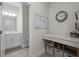 Bright mudroom with gray walls, quartz countertops, custom organization, and a half bath with white vanity at 4077 Cadence Loop, Land O Lakes, FL 34638