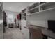 Spacious walk-in closet with custom shelving, drawers, and ample storage space, plus desk/work area at 4077 Cadence Loop, Land O Lakes, FL 34638