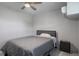 A cozy bedroom featuring a comfortable bed, ceiling fan, and bright window at 416 73Rd N Ave # 205, St Petersburg, FL 33702