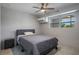 A cozy bedroom featuring a comfortable bed, ceiling fan, and bright window at 416 73Rd N Ave # 205, St Petersburg, FL 33702