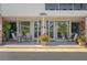 Welcoming condo building with covered front entrance featuring chairs and lovely landscaping at 416 73Rd N Ave # 205, St Petersburg, FL 33702
