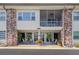 Inviting condo building exterior with brick accents and a charming entrance with seating at 416 73Rd N Ave # 205, St Petersburg, FL 33702
