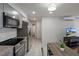 Well-lit kitchen features updated appliances, granite countertops, and easy access to the hall at 416 73Rd N Ave # 205, St Petersburg, FL 33702