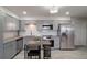 Modern kitchen with stainless steel appliances, granite countertops, and sleek gray cabinetry at 416 73Rd N Ave # 205, St Petersburg, FL 33702