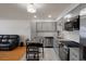 Stylish kitchen and living room featuring stainless steel appliances and an open floor plan at 416 73Rd N Ave # 205, St Petersburg, FL 33702