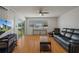 Bright living room with hardwood floors, ceiling fan, and sliding glass doors to the outside at 416 73Rd N Ave # 205, St Petersburg, FL 33702