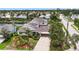 Aerial view of the home featuring mature landscaping, circular driveway, and porte cochere at 4306 Barracuda Dr, Bradenton, FL 34208