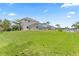 Expansive backyard with lush green lawn, mature trees, and access to waterfront and boat dock at 4306 Barracuda Dr, Bradenton, FL 34208