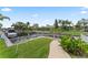 Backyard with waterfront access, a private dock, and lush tropical landscaping at 4306 Barracuda Dr, Bradenton, FL 34208