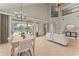 Bright dining area featuring high ceilings, an adjacent kitchen, and access to an outdoor pool area at 4306 Barracuda Dr, Bradenton, FL 34208