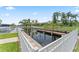 Waterfront view featuring a private boat dock surrounded by lush landscaping and picturesque scenery at 4306 Barracuda Dr, Bradenton, FL 34208
