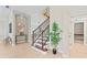 Bright foyer with staircase featuring tile flooring and modern decor at 4306 Barracuda Dr, Bradenton, FL 34208