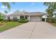 Inviting exterior with a well-manicured lawn, mature landscaping, and a covered three-car carport at 4306 Barracuda Dr, Bradenton, FL 34208
