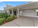 Exterior view of home with landscaped front yard and spacious carport with three-car garage at 4306 Barracuda Dr, Bradenton, FL 34208