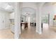 Hallway with arched doorways that lead to a laundry room on the left and office on the right at 4306 Barracuda Dr, Bradenton, FL 34208
