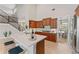 Well-lit kitchen with stainless steel appliances, custom cabinets, and an adjacent dining area at 4306 Barracuda Dr, Bradenton, FL 34208