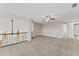 Open loft area features plush carpeting, ceiling fan and staircase with decorative iron railing at 4306 Barracuda Dr, Bradenton, FL 34208